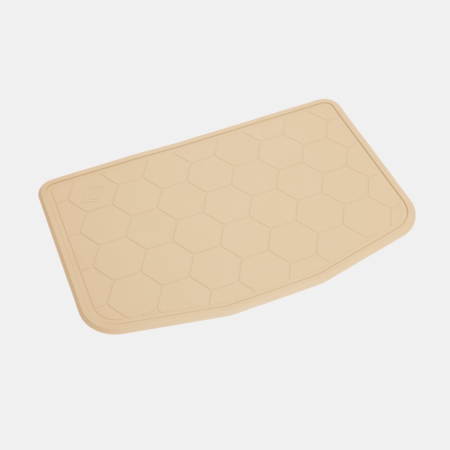 The GUNNER BOWL MAT - TAN is a beige, rectangular mat with rounded corners and a distinctive hexagonal pattern. Designed to be slip-resistant, it features a subtly uneven edge on one side and a small raised GUNNER icon in one corner. Dishwasher-safe for easy cleaning, the mat is pictured against a plain white background.