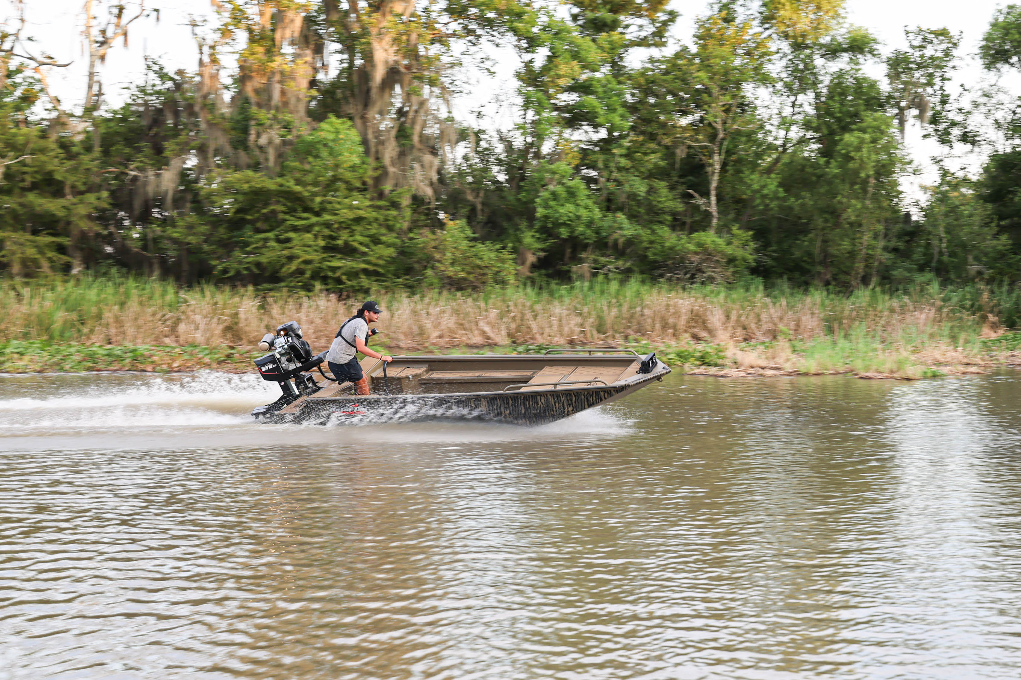 A man drive a Gatortail boat in the water.