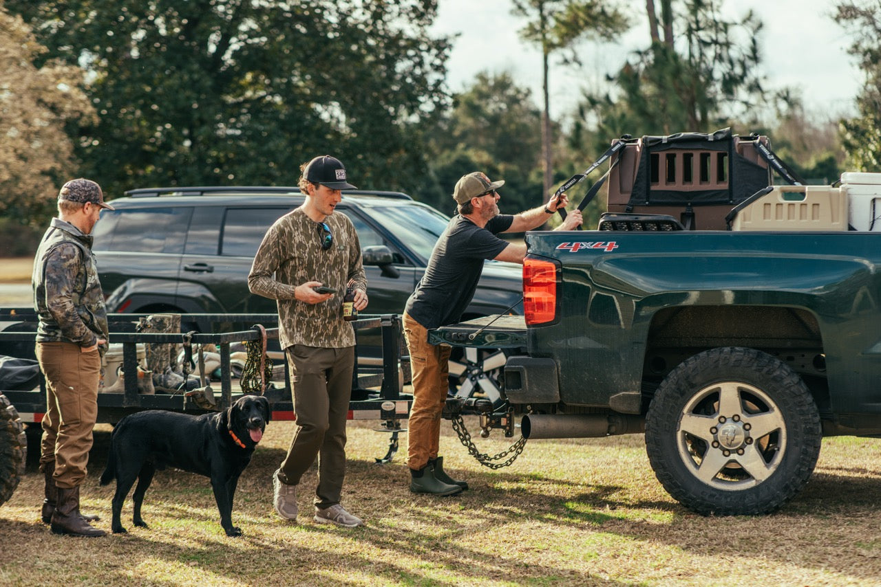 Addison reached up to open the back of his G1™ Kennel in the bed of his truck.