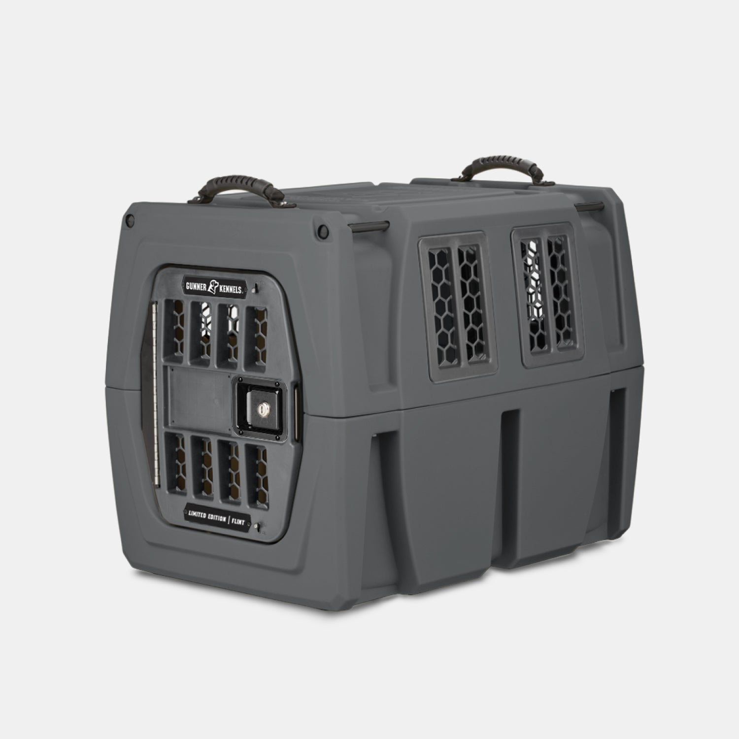 The GUNNER G1™ KENNEL - FLINT, a durable dark gray pet crate with ventilation holes, secure locking system, and dual top handles, sits on a plain white background—engineered for maximum pet safety.