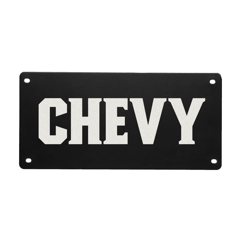 The GUNNER PERSONALIZED KENNEL NAME PLATE is a black rectangle with “CHEVY” in bold white letters centered. It has four corner holes for easy attachment, making it perfect for personalizing your dog’s crate.