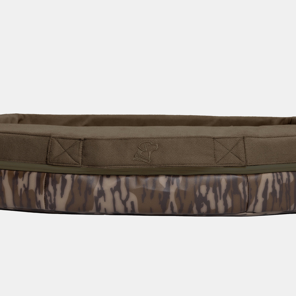 The GUNNER CAMP BED is a rectangular dog bed with a Mossy Oak Bottomland camouflage pattern, featuring raised edges and a small ax logo on the front. Designed for durability and support, this camp bed offers comfort for your canine companion whether indoors or outdoors.