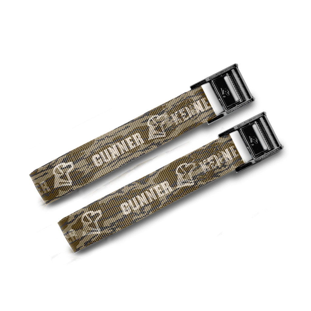 Two camouflage-patterned straps with metal buckles from the GUNNER CONNECTION STRAP KIT feature “GUNNER” and an outline of a dog’s head—perfect as kennel tie-downs or crash-tested straps. Shown on a plain white background.