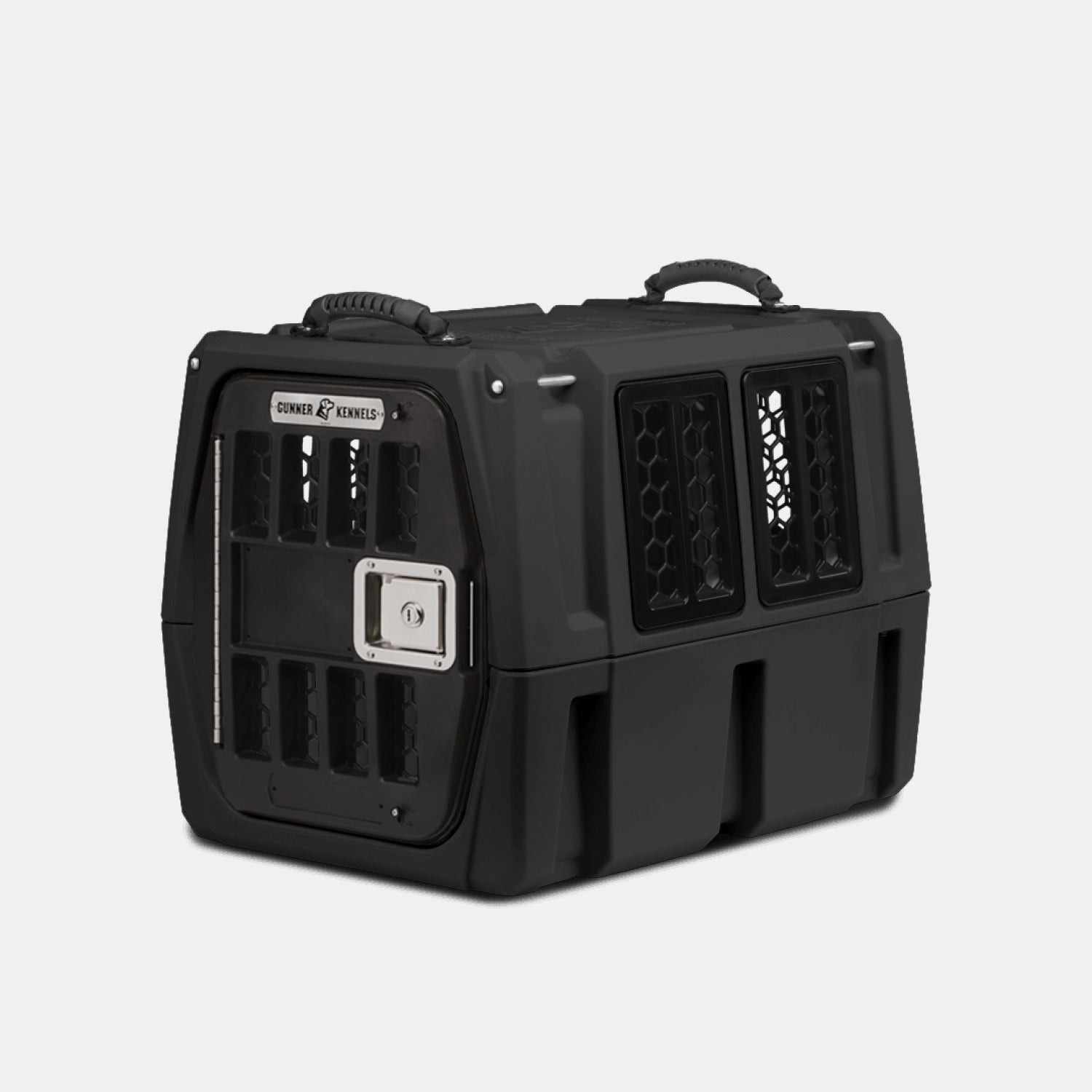 The GUNNER G1™ KENNEL - BLACK is a sturdy dog crate made of tough plastic, featuring side and front ventilation slots, a metal front door latch, and top handles for easy carrying.