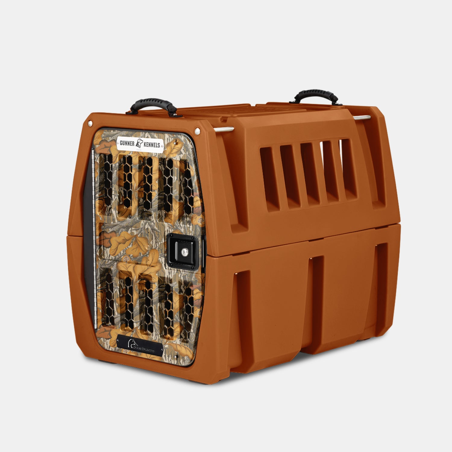 The GUNNER G1™ KENNEL - Habitat Edition is a durable brown plastic dog crate with ventilation slats, black top handles, and a secure camouflage-patterned metal door—perfect for outdoor use and inspired by Ducks Unlimited.