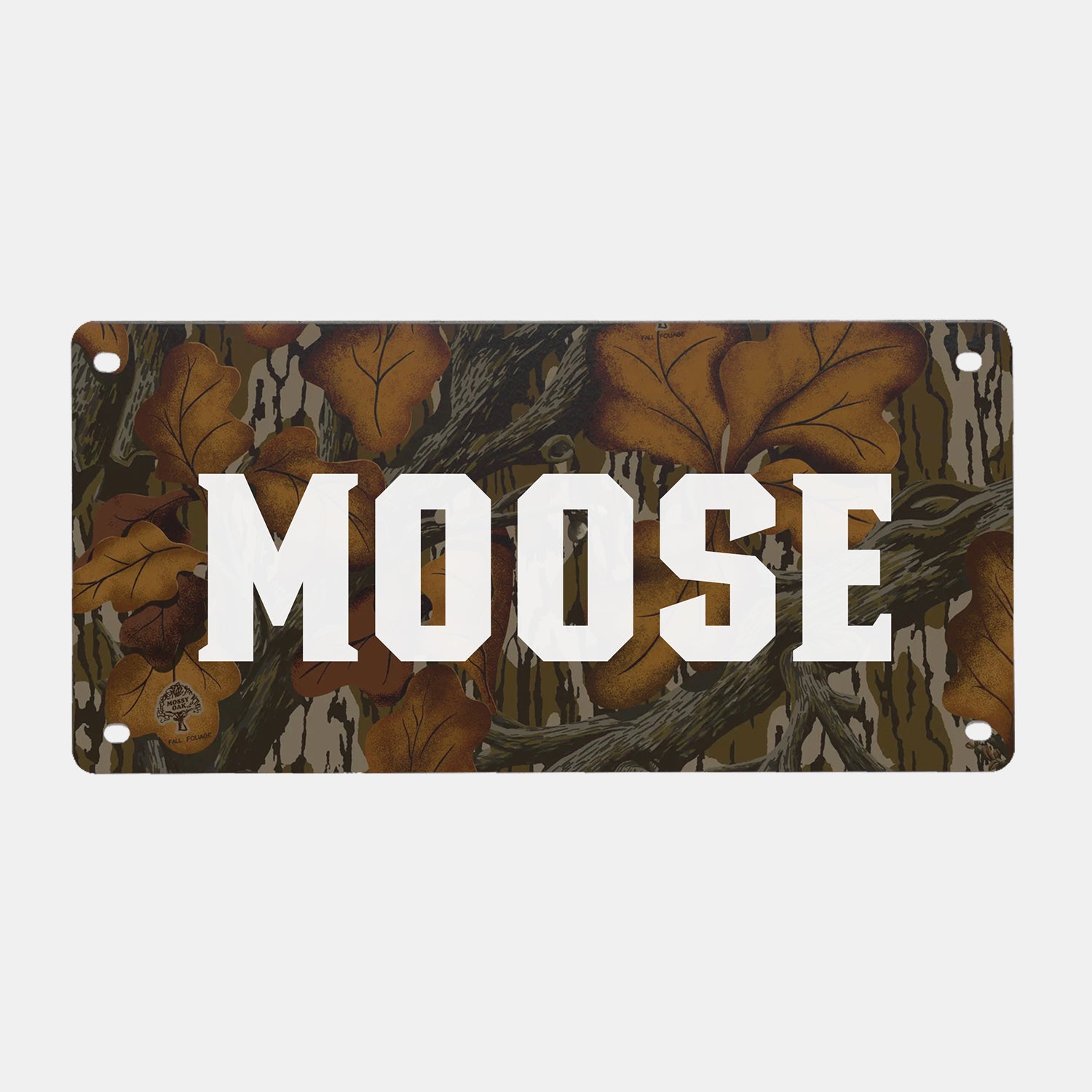 A GUNNER PERSONALIZED KENNEL NAME PLATE with a camouflage background of brown leaves and branches, reminiscent of the rugged outdoors, featuring your custom text—such as “MOOSE”—in large, bold white letters across the center; a perfect accent for your dog crate or GUNNER kennel.