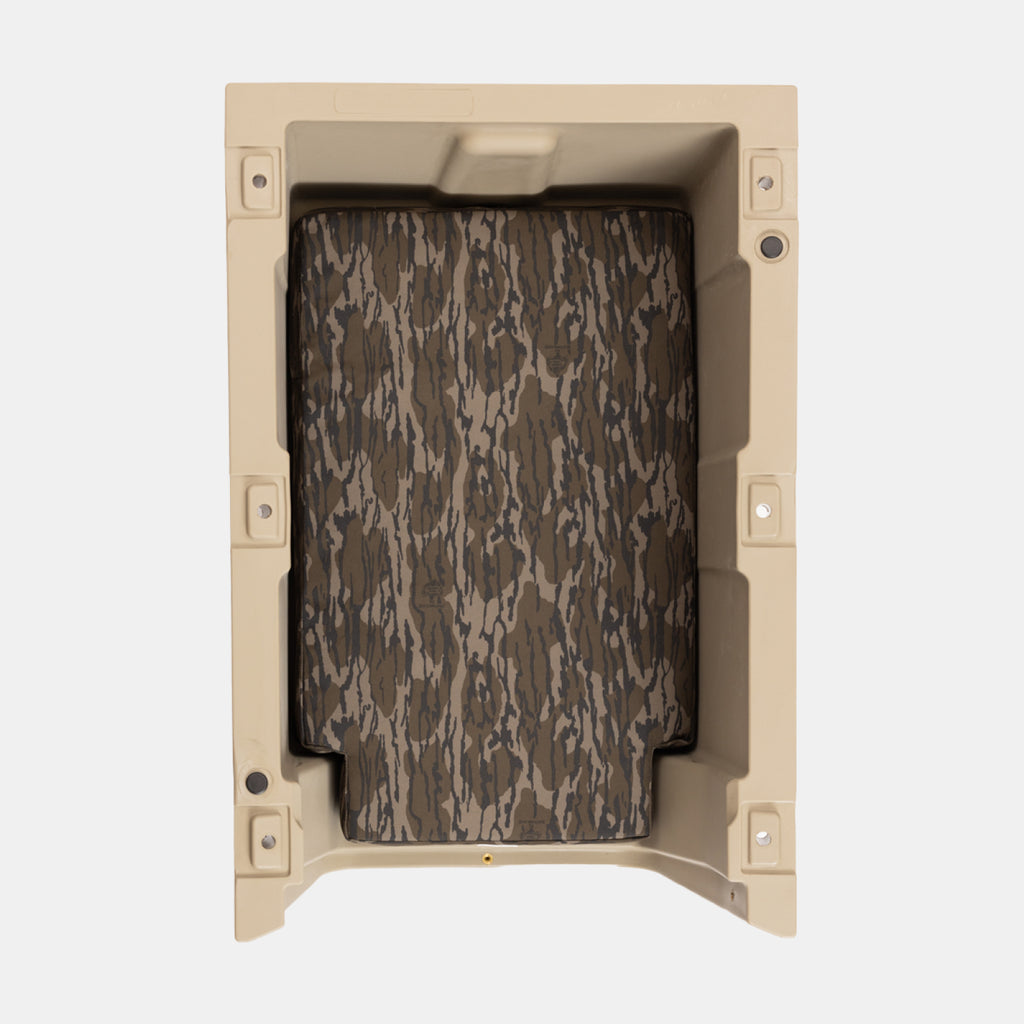The GUNNER LONG HAUL BED is a rectangular tan kennel bed featuring a camouflage-patterned panel, viewed from above on a plain white background.