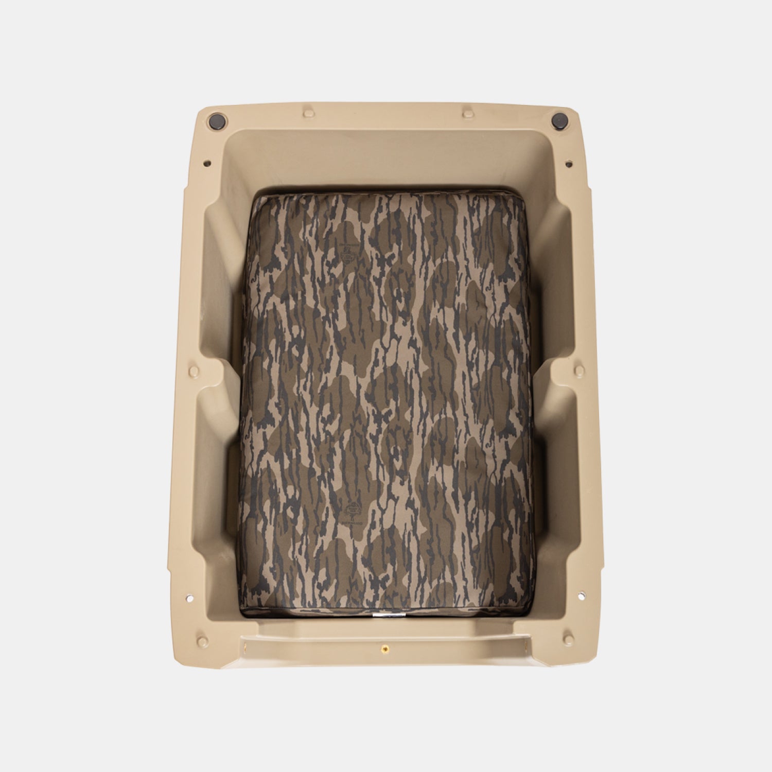 The GUNNER LONG HAUL BED is a tan rectangular plastic pet crate with a camo-patterned cushion in brown and gray, designed as a durable dog bed, shown from above on a plain white background.