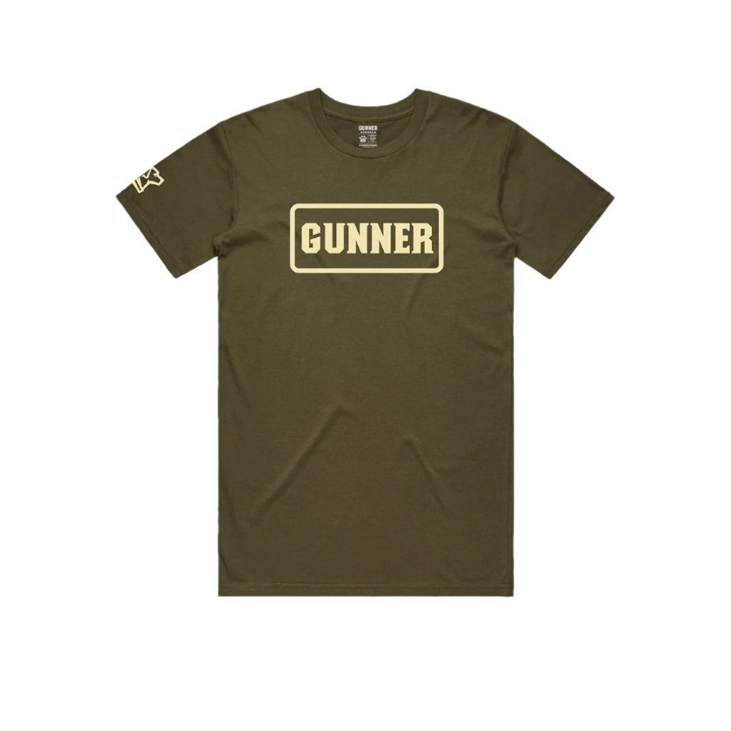 The GUNNER Pack Tee by GUNNER is a heavy-weight olive green shirt with “GUNNER” in bold beige letters inside a rectangle on the chest and a small logo on the left sleeve, shown laid flat on a white background.