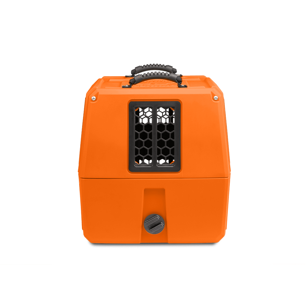 Bright orange pet carrier with a black vented window and handle, ideal for outdoor gear or transporting your working dog. The hexagonal grid pattern on the window and round gray latch near the bottom add both style and security.