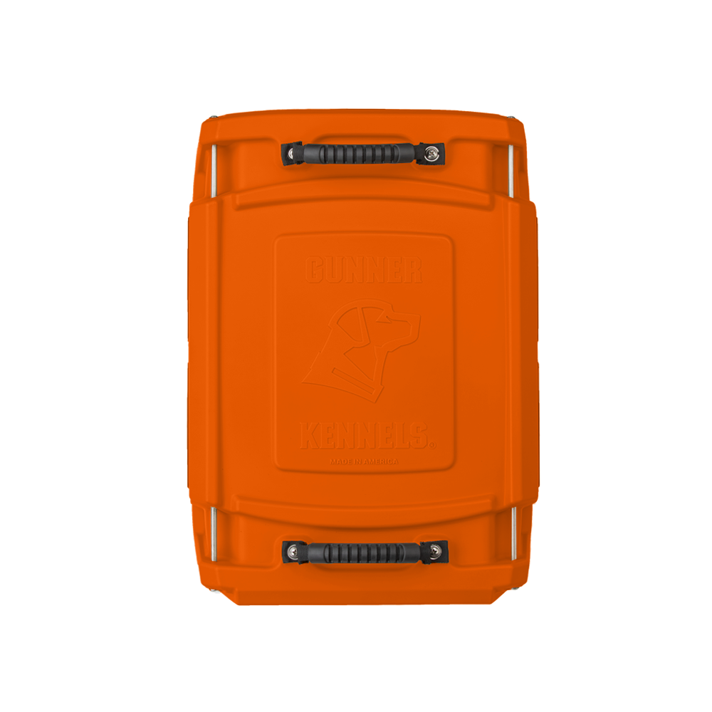 Bright orange hard-sided dog crate viewed from above, featuring two black handles and embossed “Gunner Kennels” text with a dog outline on the lid—rugged outdoor gear designed for your working dog’s safety and comfort.