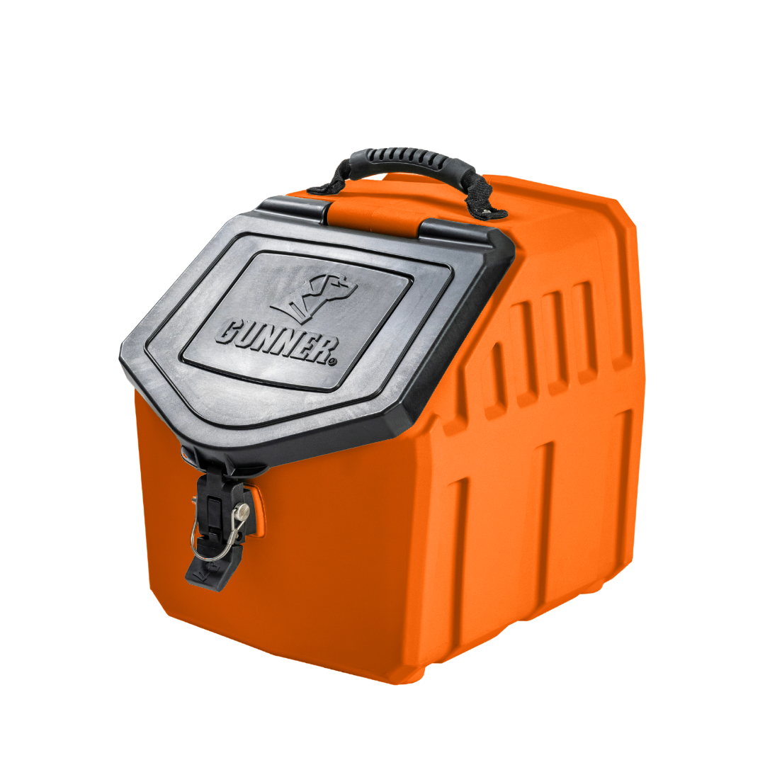 The GUNNER FOOD CRATE - BLAZE ORANGE is a heavy-duty dog food container with a black hinged lid, secure front latch, handle, and GUNNER plus a dog logo embossed on top—part of the limited-edition Color Fetch series by GUNNER.